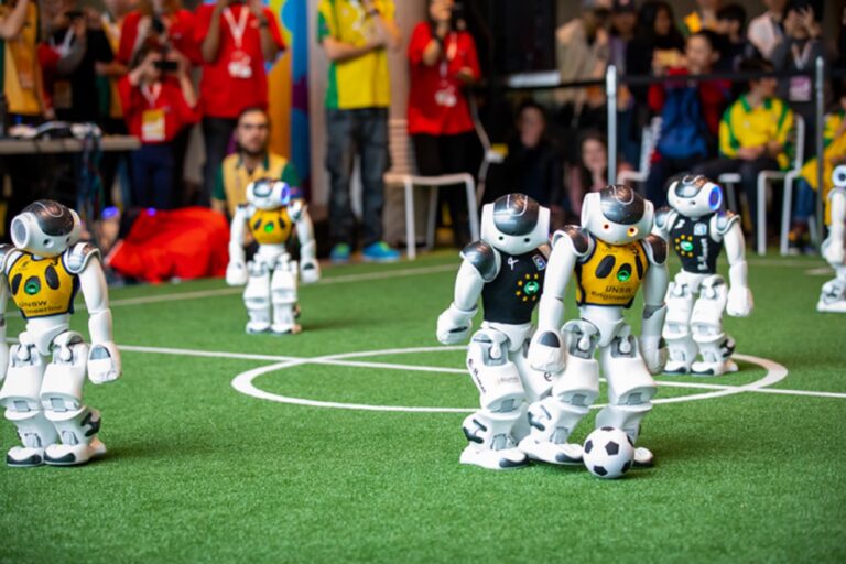 Watch 2 good tiny, AI robots play soccer